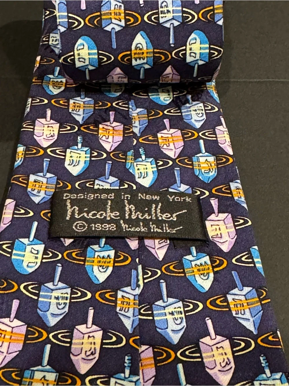 Hanukkah inspired silk tie with dreidel pattern by Nicole Miller NYC